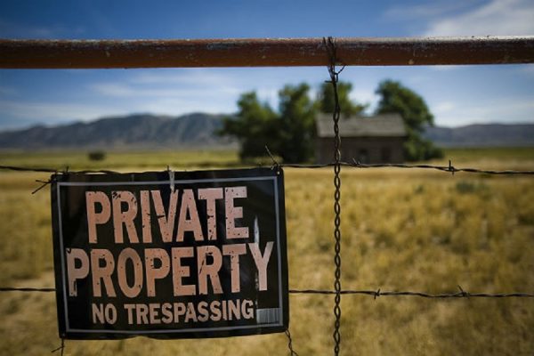 What is the legality behind the "Trespassers Will Be Shot" sign?